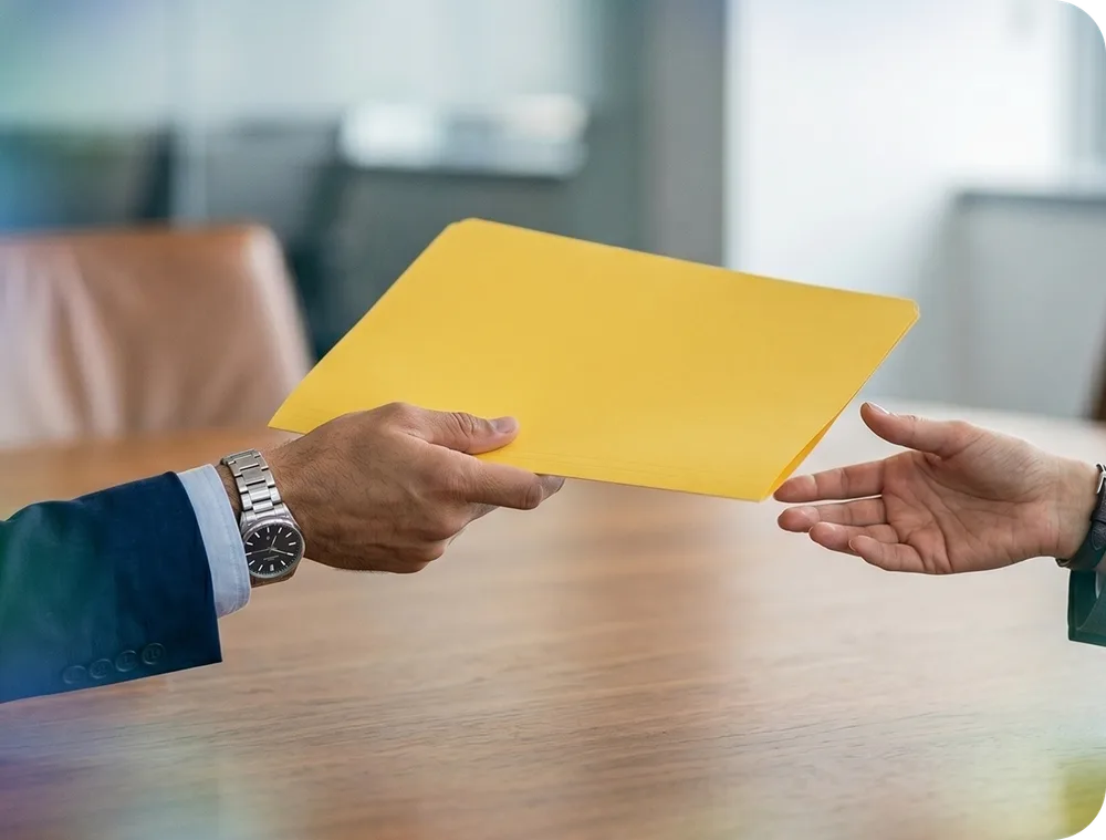 Handing over a document folder across a desk